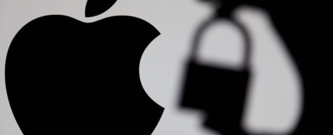 LONDON, UK - MAY 15th 2017: Apple security issues. Silhouette of a hand holding a padlock infront of the apple logo